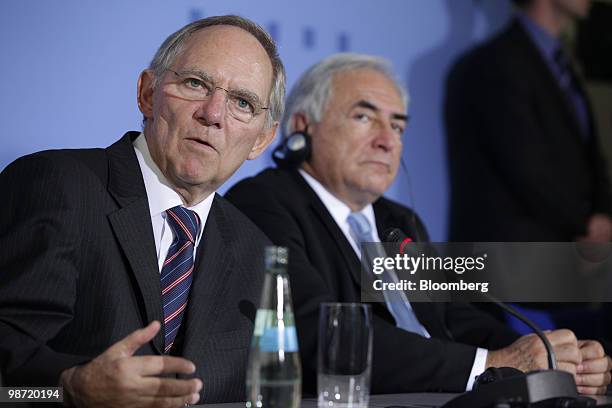 Wolfgang Schaeuble, Germany's finance minister, left, speaks as Dominique Strauss-Kahn, managing director of the International Monetary Fund ,...