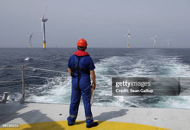 Worker looks out at wind turbines at the Alpha Ventus offshore windpark on April 28, 2010 in the North Sea approximately 70km north of the German...