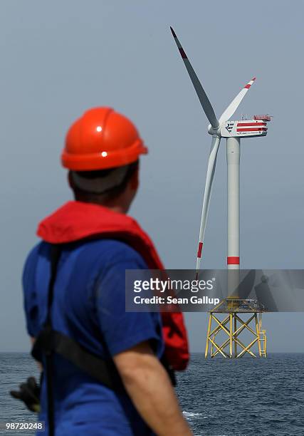 Worker looks out at wind turbines at the Alpha Ventus offshore windpark on April 28, 2010 in the North Sea approximately 70km north of the German...