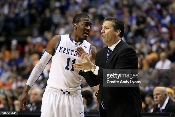 John Wall and head coach John Calipari of the Kentucky Wildcats talk on the sideline against the Alabama Crimson Tide during the quarterfinals of the...