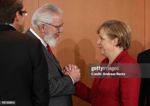 German Chancellor Angela Merkel welcomes Juan Somavia, director general of the International Labour Organization, prior to a meeting at the...