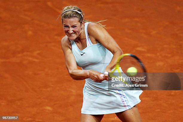 Victoria Azarenka of Belarus plays a backhand during her first round match against Flavia Pennetta of Italy at day three of the WTA Porsche Tennis...