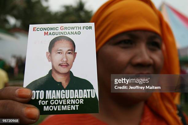 Supporter of Buluan Vice Mayor and candidate for governor of Maguindanao Esmael "Toto" Mangudadatu, holds a card during campaign rally on April 28,...
