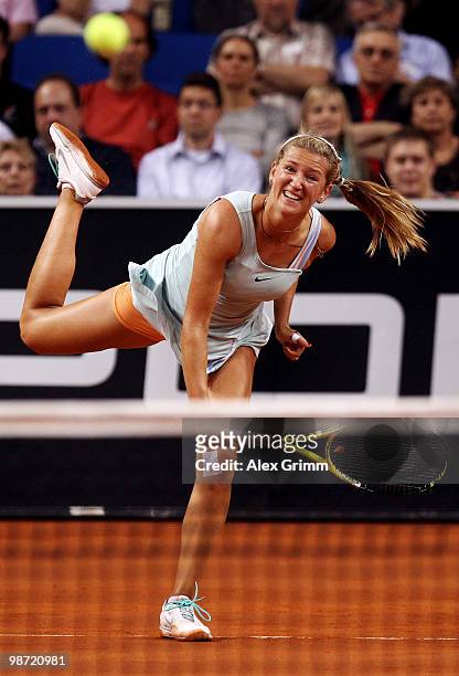 Victoria Azarenka of Belarus serves the ball during her first round match against Flavia Pennetta of Italy at day three of the WTA Porsche Tennis...