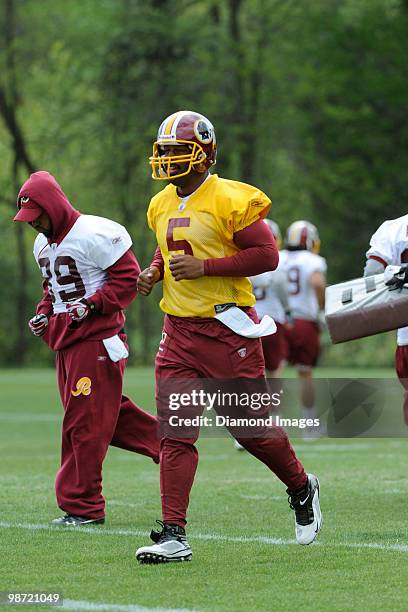 Quarterback Donovan McNabb of the Washington Redskins jogs towards the next drill location during a mini camp on April 18, 2010 at Redskins Park in...