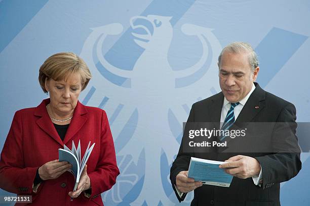 German Chancellor Angela Merkel talks to OECD Secretary-General Jose Angel Gurria during the handover of the OECD Report at the Chancellery on April...