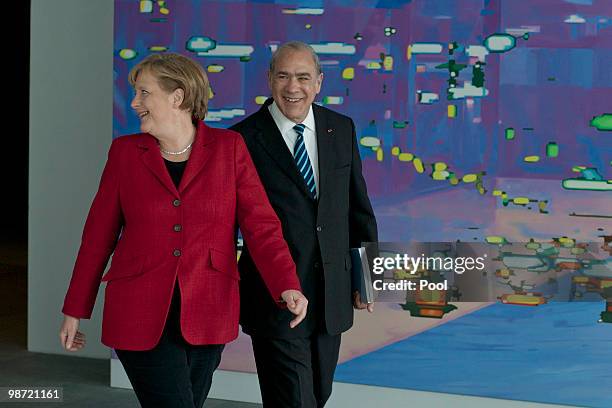 German Chancellor Angela Merkel talks to OECD Secretary-General Jose Angel Gurria during the handover of the OECD Report at the Chancellery on April...