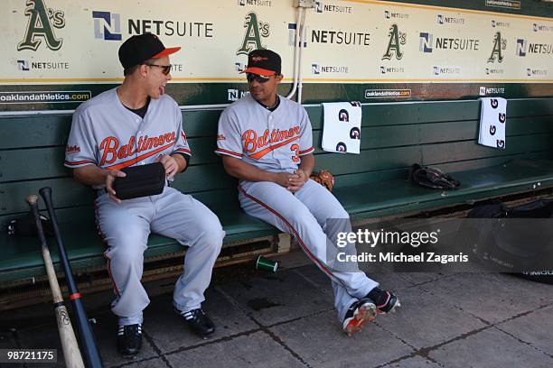 Lou Montanez of the Baltimore Orioles clowning around with teammate Cesar Izturis in the dugout prior to the game against the Oakland Athletics at...