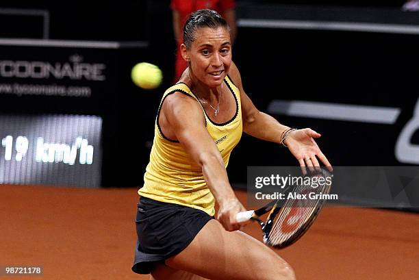 Flavia Pennetta of Italy plays a backhand during her first round match against Victoria Azarenka of Belarus at day three of the WTA Porsche Tennis...