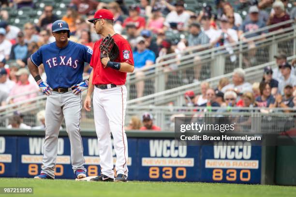 Adrian Beltre of the Texas Rangers talks with Joe Mauer of the Minnesota Twins on June 24, 2018 at Target Field in Minneapolis, Minnesota. The Twins...