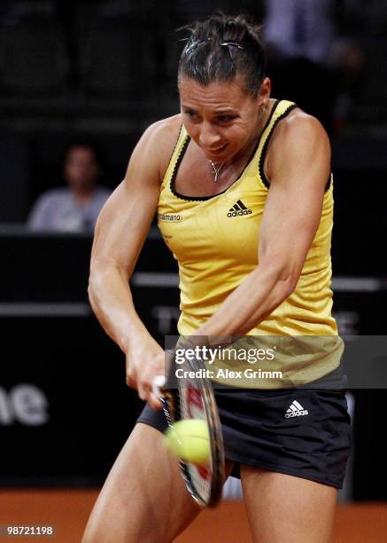 Flavia Pennetta of Italy plays a backhand during her first round match against Victoria Azarenka of Belarus at day three of the WTA Porsche Tennis...
