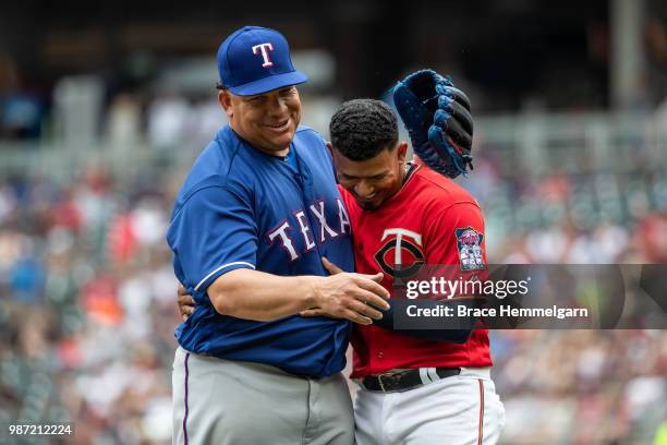 Bartolo Colon of the Texas Rangers talks with Eduardo Escobar of the Minnesota Twins on June 24, 2018 at Target Field in Minneapolis, Minnesota. The...