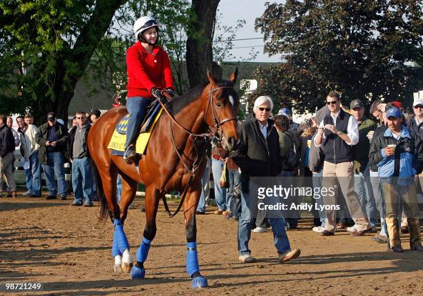 Bob Baffert the trainer of Lookin at Lucky walks beside the horse during the morning workouts for the Kentucky Derby at Churchill Downs on April 28,...