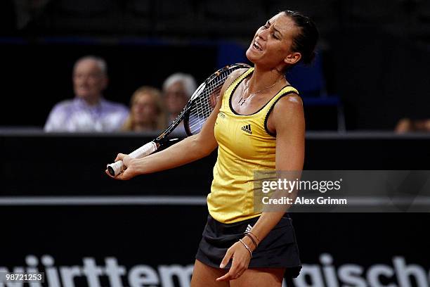 Flavia Pennetta of Italy reacts during her first round match against Victoria Azarenka of Belarus at day three of the WTA Porsche Tennis Grand Prix...