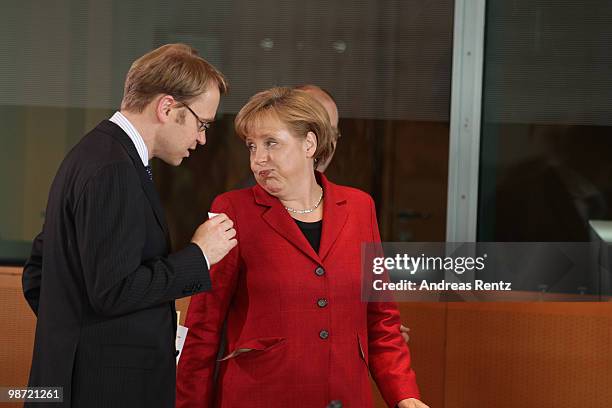 German Chancellor Angela Merkel gestures as her economic adviser Jens Weidmann looks on prior to a meeting at the Chancellery on April 28, 2010 in...