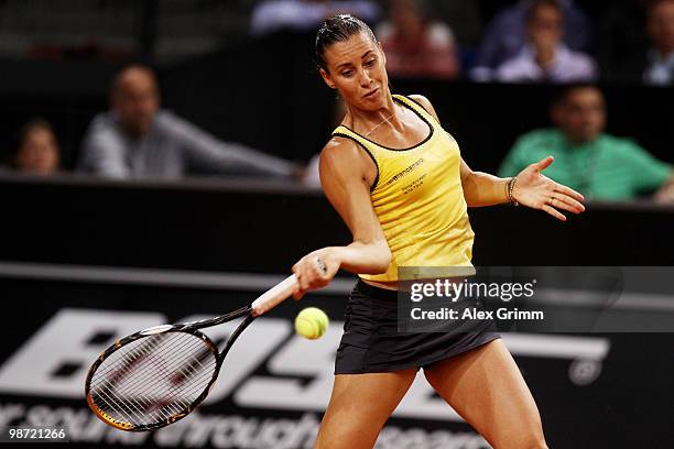 Flavia Pennetta of Italy plays a forehand during her first round match against Victoria Azarenka of Belarus at day three of the WTA Porsche Tennis...