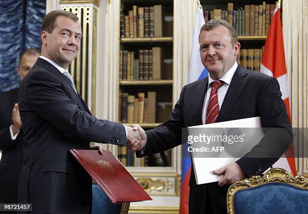 Russian President Dmitry Medvedev and Danish Prime Minister Lars Loekke Rasmussen pose during a signing ceremony at Christiansborg Palace's Queen's...