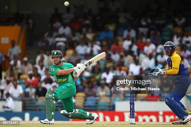 Mark Boucher of South Africa hits out as Kumar Sangakkara looks on during The ICC T20 World Cup warm up match between Sri Lanka and South Africa at...