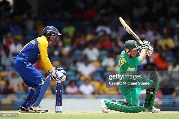 De Villiers of South Africa plays to the onside as Kumar Sangakkara looks on during The ICC T20 World Cup warm up match between Sri Lanka and South...