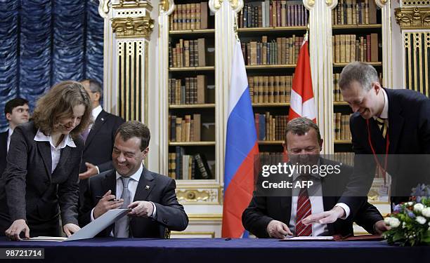 Russian President Dmitry Medvedev and Danish Prime Minister Lars Loekke Rasmussen look at documents during a signing ceremony at Christiansborg...