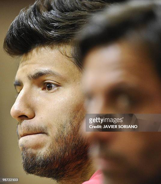 Atletico Madrid's Argentinian forward Sergio Aguero attends a press conference next to his coach Quique Sanchez Flores before their training session...