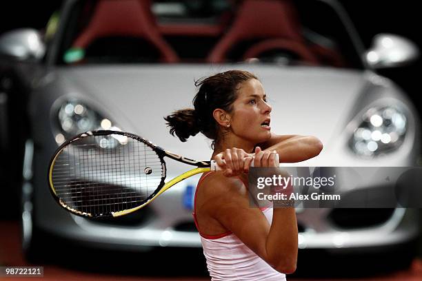 Julia Goerges of Germany plays a backhand during her first round match against Justine Henin of Belgium at day three of the WTA Porsche Tennis Grand...