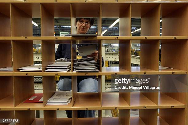 Woman sorts letters by hand on April 28, 2010 in Munich, Germany. Deutsche Post DHL held its Annual General Meeting for financial year 2009 on 28...