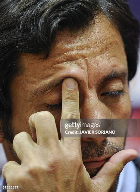 Atletico Madrid's coach Quique Sanchez Flores rubs his eye during a press conference before his team's training session on April 28, 2010 at Anfield...