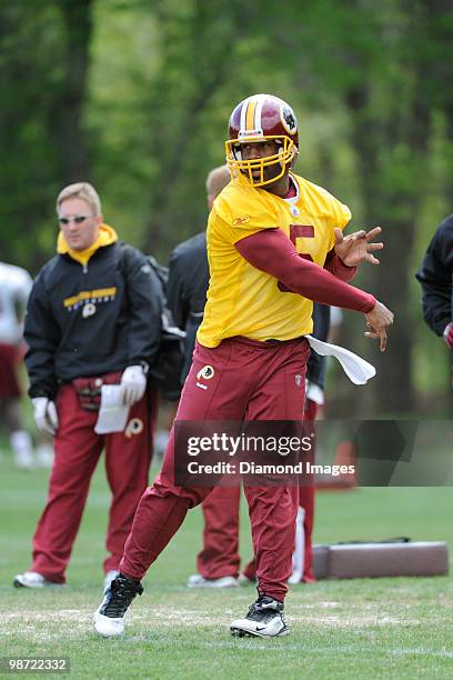 Quarterback Donovan McNabb of the Washington Redskins follows through after throwing a pass during a mini camp on April 18, 2010 at Redskins Park in...