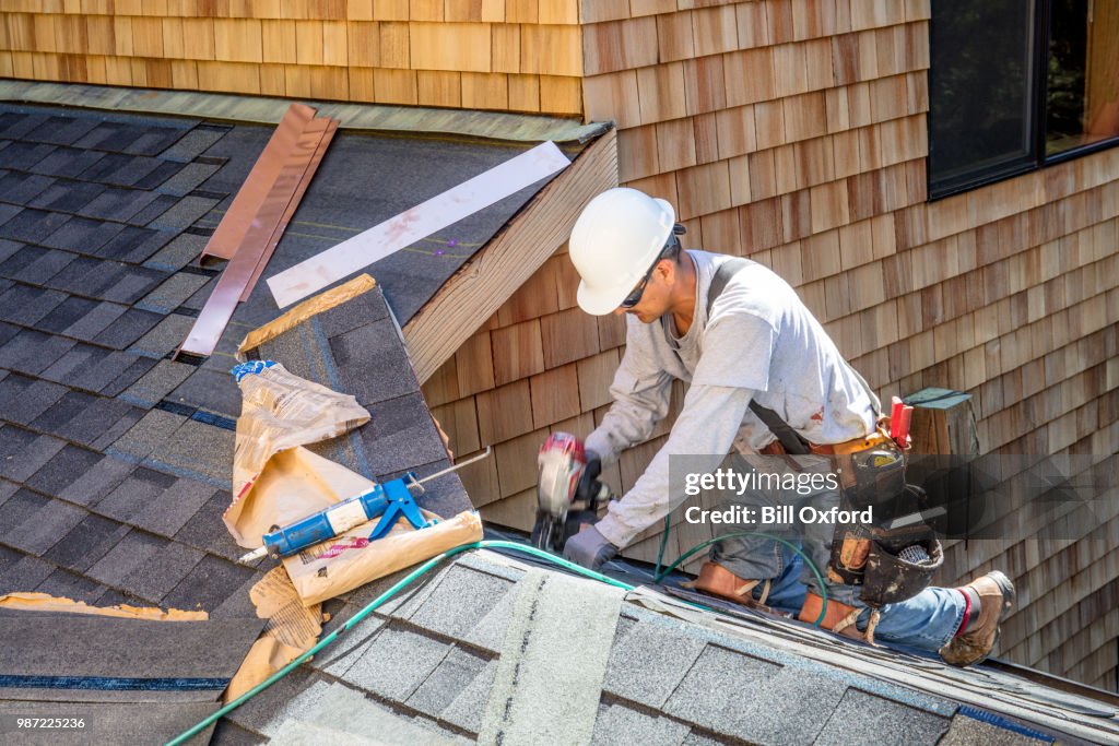 Installing new roof with nail gun