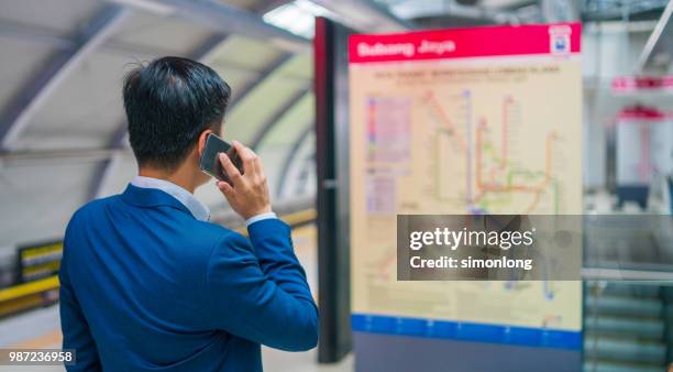 asian young man looking at the map at the train station - looking at subway map bildbanksfoton och bilder