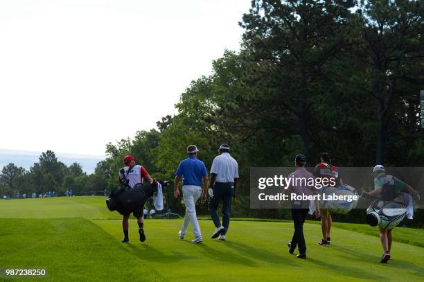 Davis Love III, Vijay Singh of Fiji and David Toms walk to the 10th fair way during round two of the U.S. Senior Open Championship at The Broadmoor...