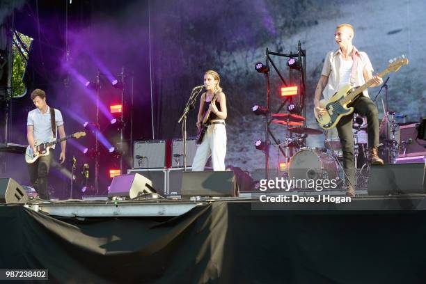 Joff Oddie, Ellie Rowsell and Theo Ellis of Wolf Alice support Liam Gallagher on stage at Finsbury Park on June 29, 2018 in London, England.