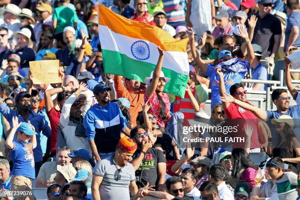 Indian supporters cheer another wicket during the Twenty20 International cricket match between Ireland and India at Malahide cricket club, in Dublin...