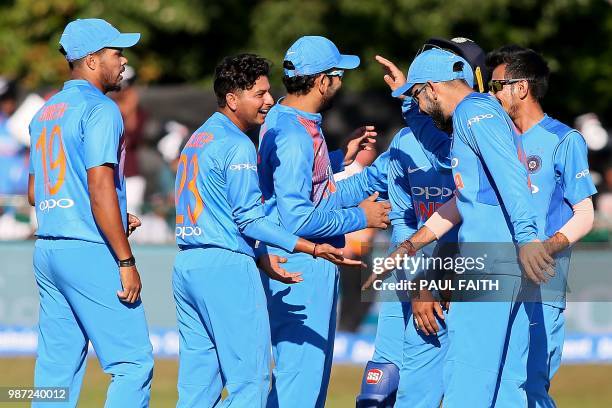 Indian players celebrate taking another wicket during the Twenty20 International cricket match between Ireland and India at Malahide cricket club, in...