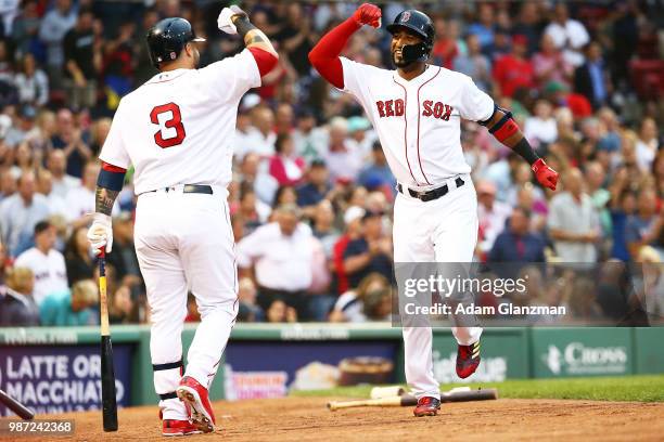 Eduardo Nunez high fives Sandy Leon of the Boston Red Sox after hitting a solo home run in the second dining of a game against the Los Angeles Angels...