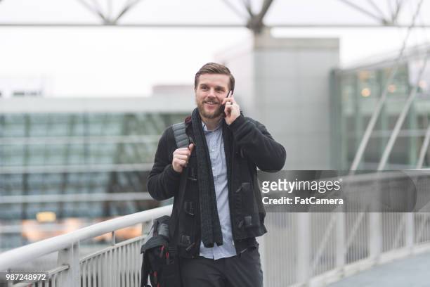 male traveler at airport - male airport stock pictures, royalty-free photos & images