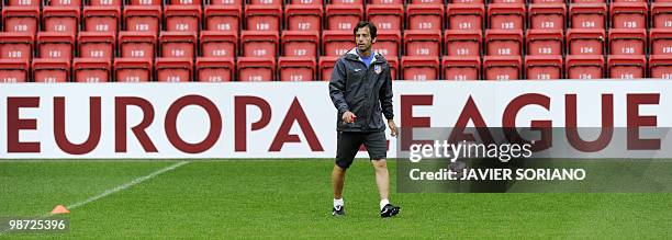 Atletico Madrid's coach Quique Sanchez Flores walks during a training session on April 28, 2010 at Anfield stadium in Liverpool, on the eve of their...