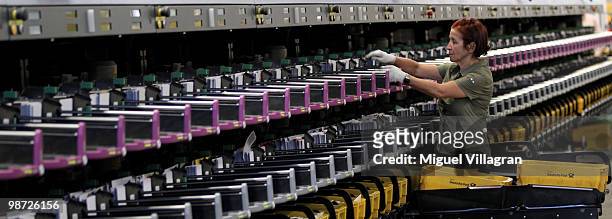 Woman takes out sorted letters out of an automatic sorting machine at the Deutsche Post DHL sorting center on April 28, 2010 in Munich, Germany....