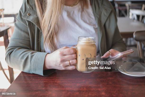 beautiful woman drinking iced coffee - alas stockfoto's en -beelden