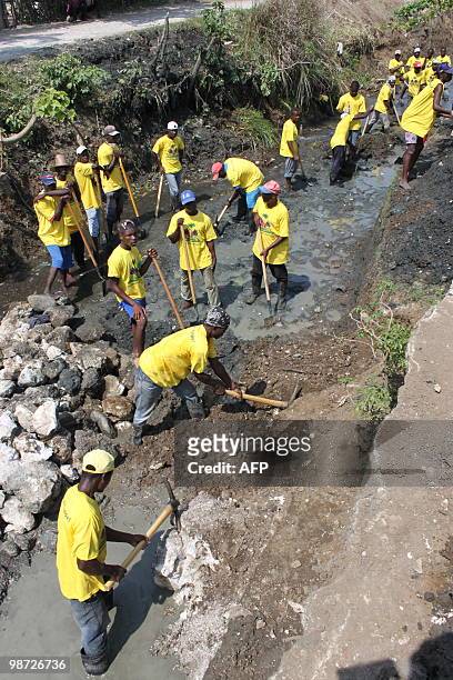 By Clement Sabourin Haitians clean out a canal in Leogane, Haiti April 23, 2010 where the french NGO Acted employs dozens of people for these "cash...