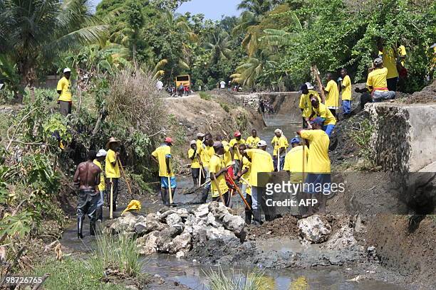 By Clement Sabourin Haitians clean out a canal in Leogane, Haiti April 23, 2010 where the french NGO Acted employs dozens of people for these "cash...