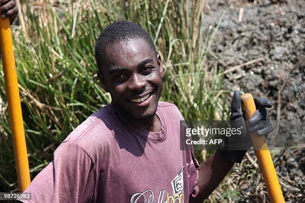 Haitians clean out a canal in Leogane, Haiti April 23, 2010 where the french NGO Acted employs dozens of people for these "cash for work" job. After...