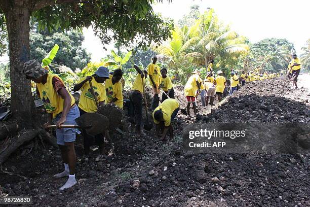 Haitians clean out a canal in Leogane, Haiti April 23, 2010 where the french NGO Acted employs dozens of people for these "cash for work" job. After...