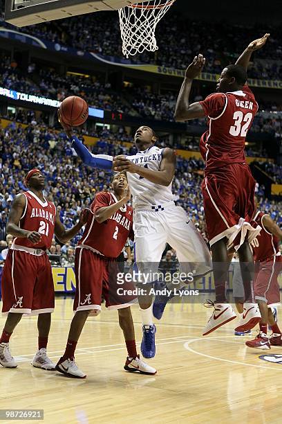 John Wall of the Kentucky Wildcats drives for a shot attempt against the Alabama Crimson Tide during the quarterfinals of the SEC Men's Basketball...