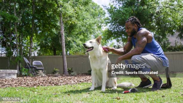Where Are They Now: Portrait of former NFL wide receiver Percy Harvin with one of his dogs during photo shoot in his backyard. Still shot from video...