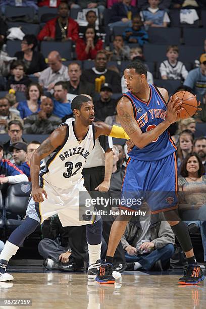 Tracy McGrady of the New York Knicks looks to move the ball against O.J. Mayo of the Memphis Grizzlie on March 12, 2010 at FedExForum in Memphis,...