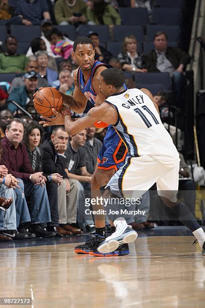 Tracy McGrady of the New York Knicks moves the ball against Mike Conley of the Memphis Grizzlie on March 12, 2010 at FedExForum in Memphis,...