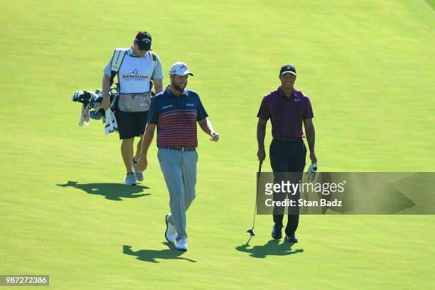 Marc Leishman of Australia and Tiger Woods approach the 15th green during the second round of the Quicken Loans National at TPC Potomac at Avenel...