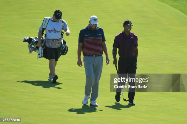 Marc Leishman of Australia and Tiger Woods approach the 15th green during the second round of the Quicken Loans National at TPC Potomac at Avenel...